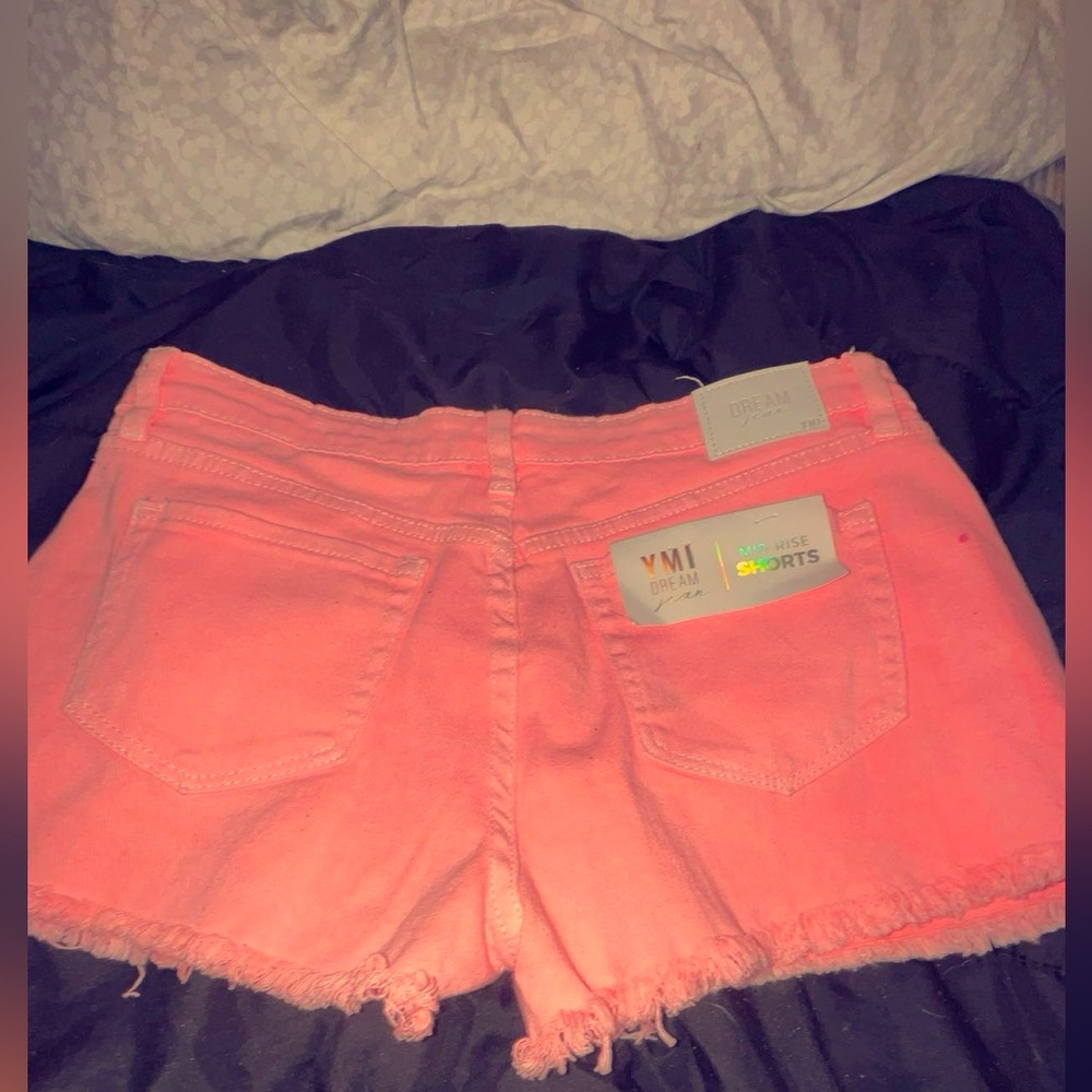 YMI  mid rise pink jean shorts.